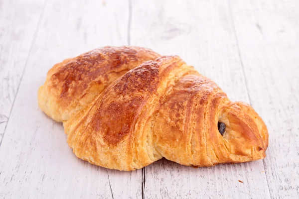 Croissant, fa felületre — Stock Fotó