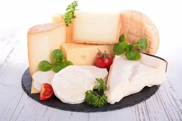 Cheese with tomatoes and herbs — Stock Photo, Image