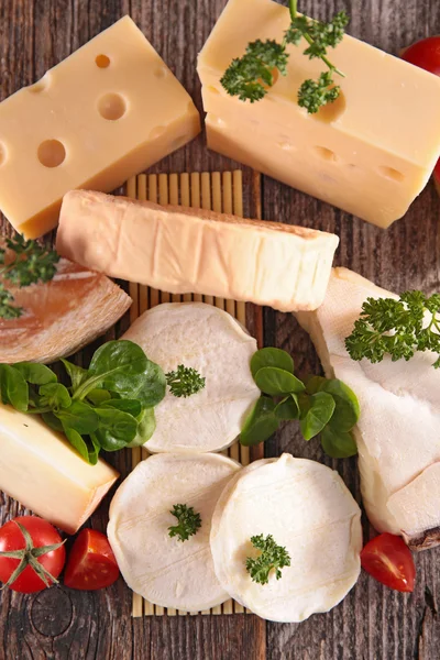 Cheese with tomatoes and herbs — Stock Photo, Image