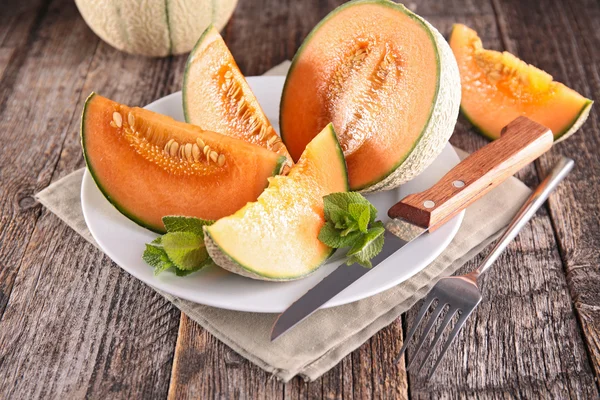 Sliced melons with mint — Stock Photo, Image