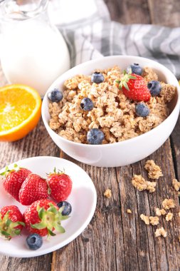 Granola with berries and milk clipart