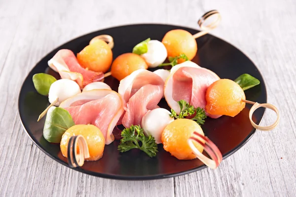 Buffet food with melon and mozzarella — Stock Photo, Image