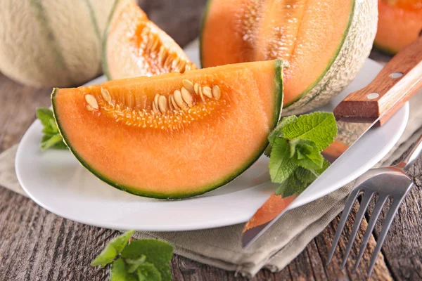 Sliced melons with mint — Stock Photo, Image