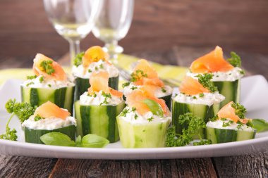 Finger food with cucumber,cheese and salmon clipart