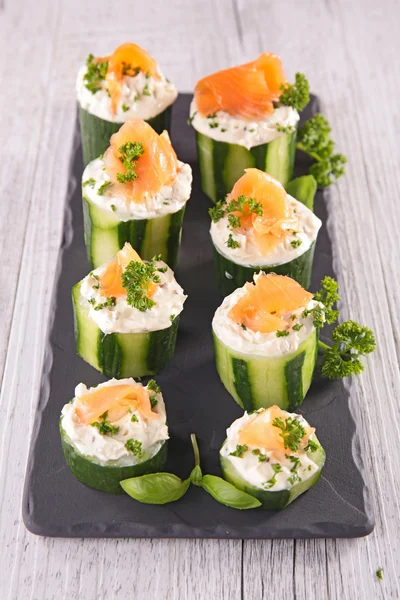 Finger food with cucumber, cheese and salmon — стоковое фото