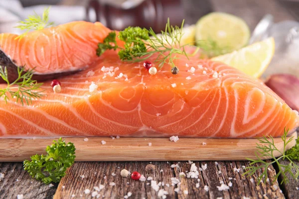 Raw salmon with spices on board — Stock Photo, Image