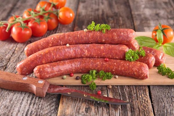 Raw sausages with herb and tomatoes — Stock Photo, Image