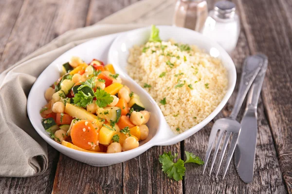 Couscous and vegetables in white plate — Stock Photo, Image