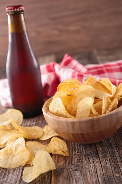 Potato chips and beer bottle — Stock Photo, Image