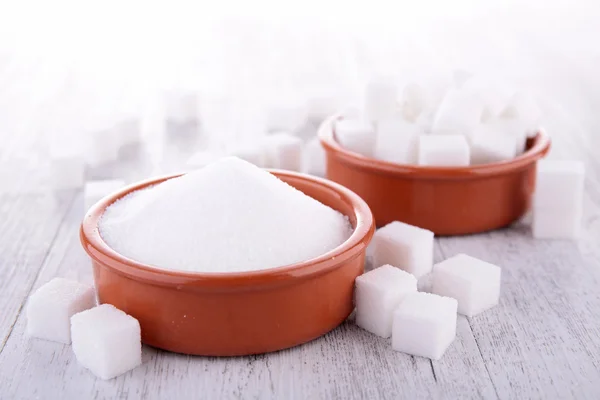 Sugar cube and powder in bowls — Stock Photo, Image