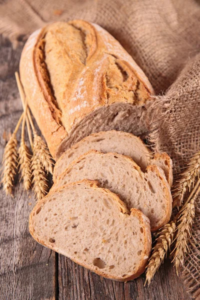 Fresh whole and sliced bread — Stock Photo, Image