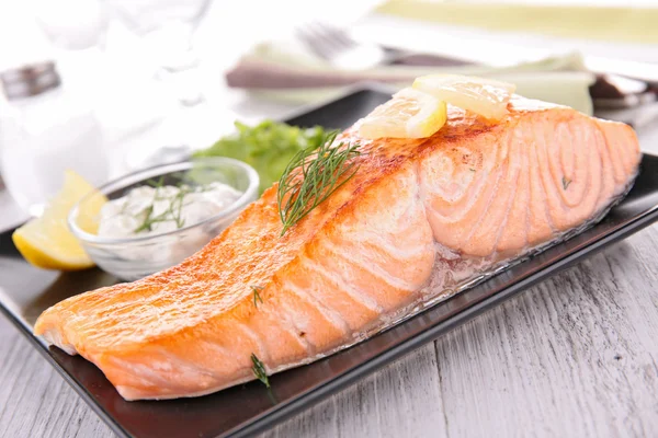 Baked salmon fillet with herb and sauce — Stock Photo, Image