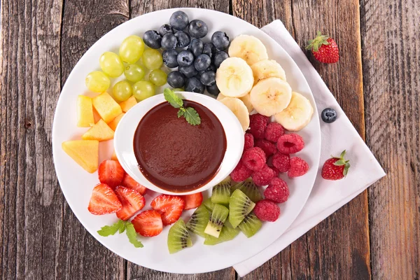 Fruits and chocolate dip — Stock Photo, Image