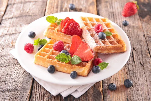 Waffles and berry fruit in white plate — Stockfoto