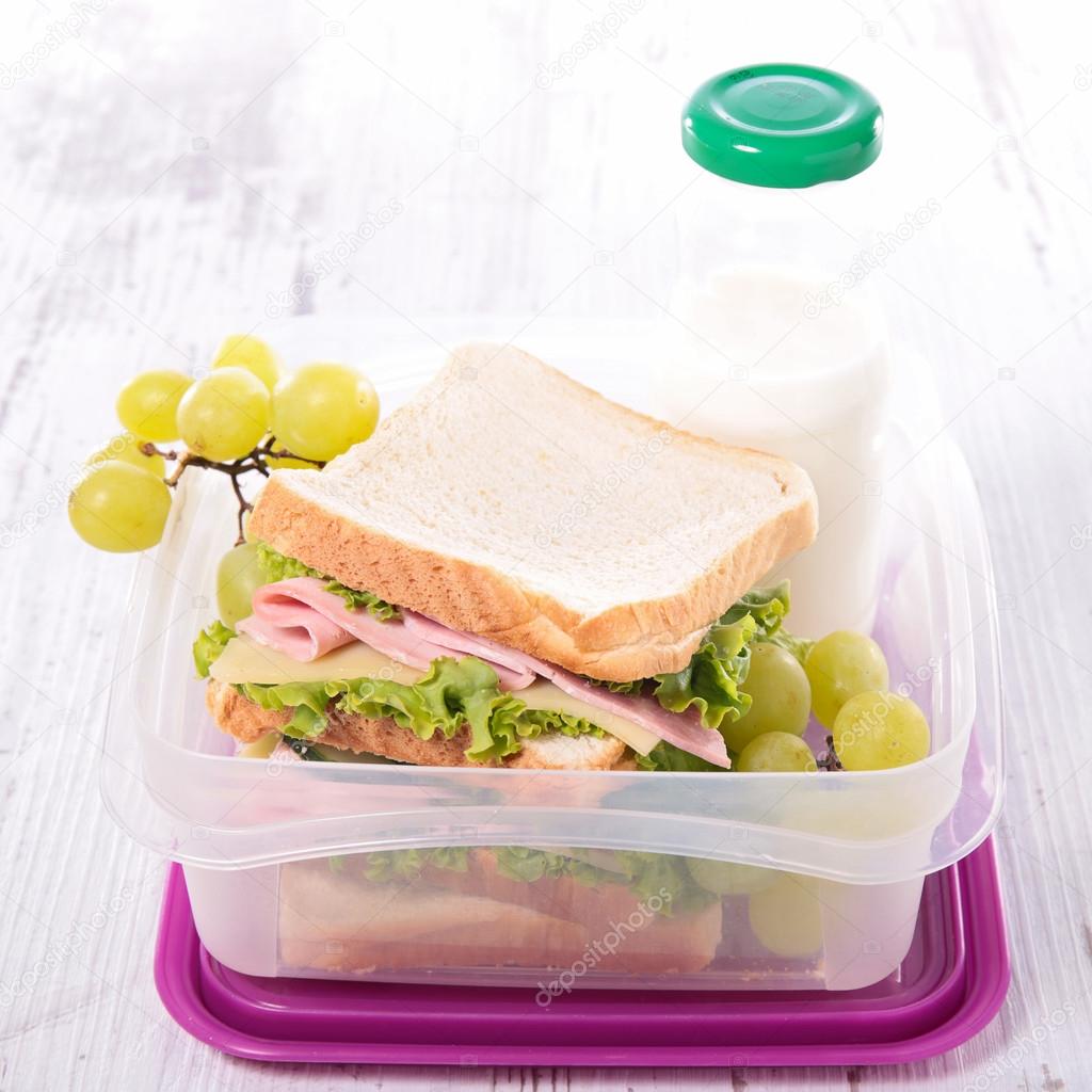 Lunch box with sandwich and grapes