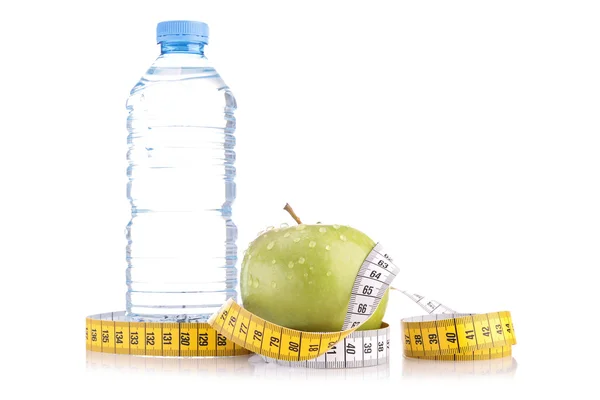 Water bottle and green apple with meter Royalty Free Stock Photos