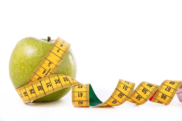 Green apple and measuring tape — Stock Photo, Image