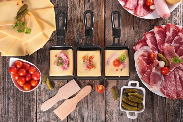 Raclette cheese with delicatessen — Stock Photo, Image