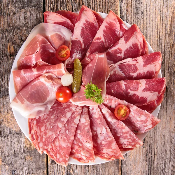 Plate of bacon, ham, salami — Stock Photo, Image