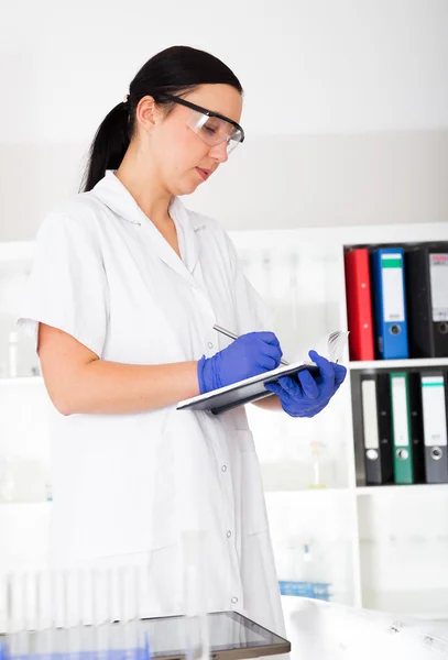 Female doctor is writing prescription — Stock Photo, Image