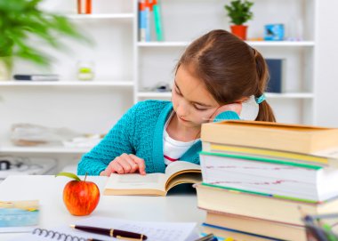 Young school girl reading a book clipart