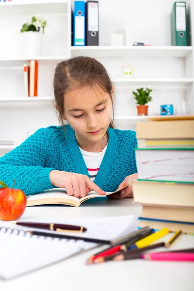 Young school girl reading a book — Stock Photo, Image