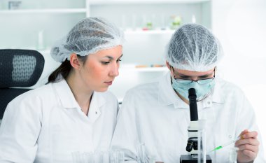 Bilim adamlarının bir laboratuvar kimyasal test üzerinde çalışan ekip.