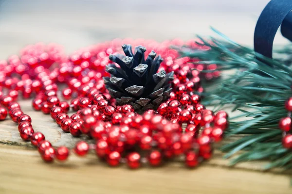 Christmas balls and spruce twigs on wooden background. — Stock Photo, Image