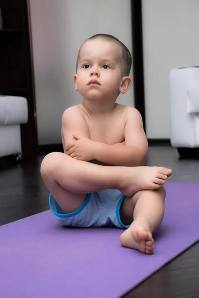 Pojke på yogamatta — Stockfoto