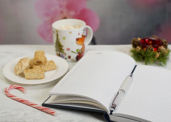 Open notebook with cup of coffee — Stock Photo, Image