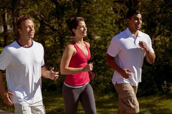 Three Athletic Friends Jogging in the Park — Stock Photo, Image