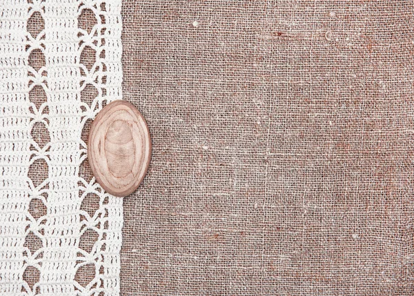 Vintage background with lace on the old burlap — Stock Photo, Image