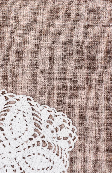 Vintage background with lace on the old burlap — Stock Photo, Image