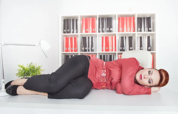 Tired businesswoman sleeping on the table — Stock Photo, Image