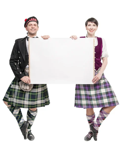 Pair of dancers of Scottish dance with empty banner — Stock Photo, Image