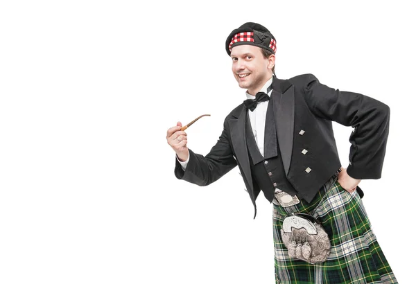 Escocês homem em traje nacional tradicional com cachimbo de fumar — Fotografia de Stock