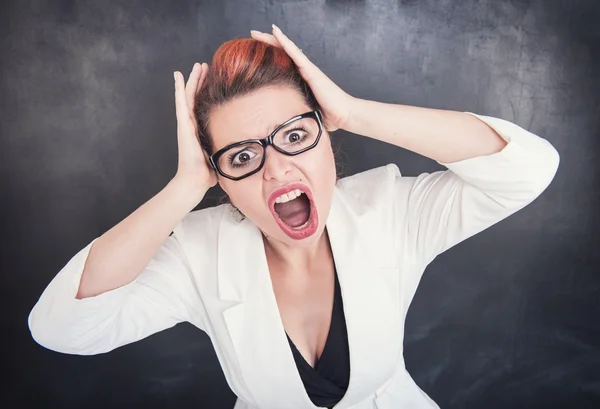 Angry screaming teacher on blackboard background — Stock Photo, Image