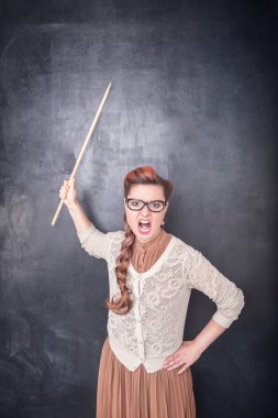 Angry screaming teacher with pointer on blackboard background clipart