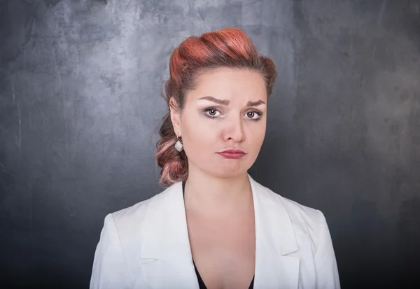 Sad woman on the blackboard background — Stock Photo, Image