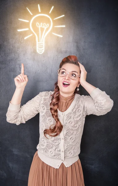 Woman showing on drawing lamp by finger — Stock Photo, Image