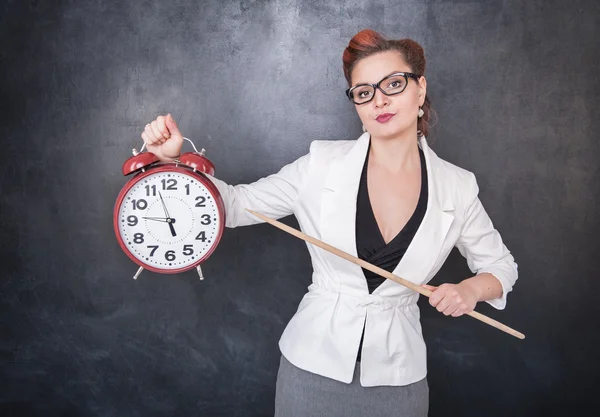 Beautiful strict teacher with clock — Stock Photo, Image