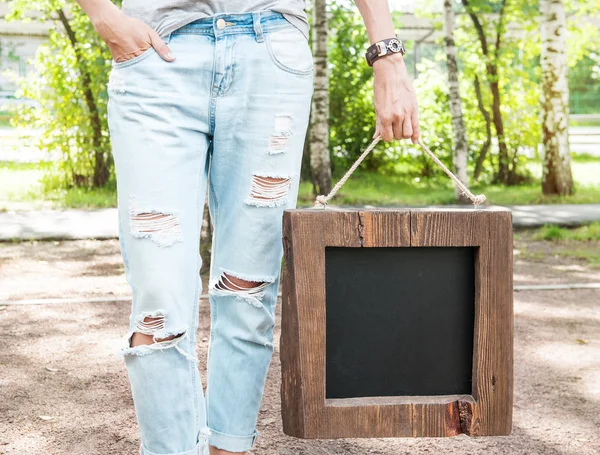 Woman holding empty blackboard with wooden frame. Template Mock — Stock Photo, Image