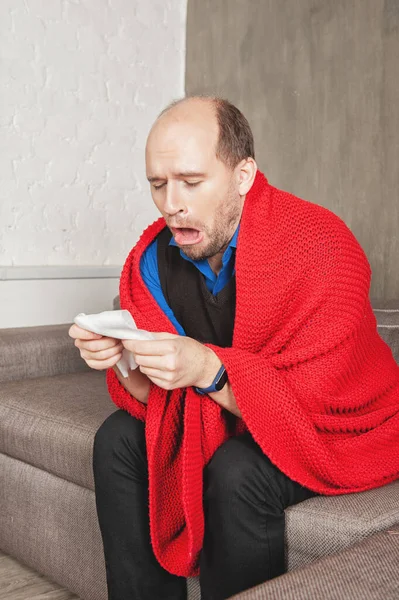 Sick Man Runny Nose Wrapped Warm Knitted Red Plaid Sneezes — Stock Photo, Image