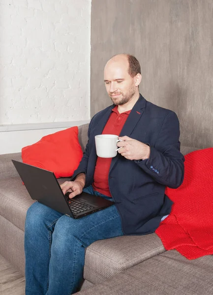 Happy Business man with cup of drink working at home. Online work or study concept