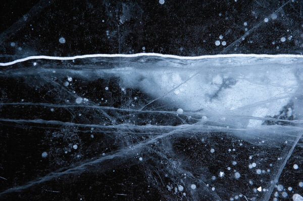 Ice texture with scratches and frozen bubbles. Winer abstract background for desig