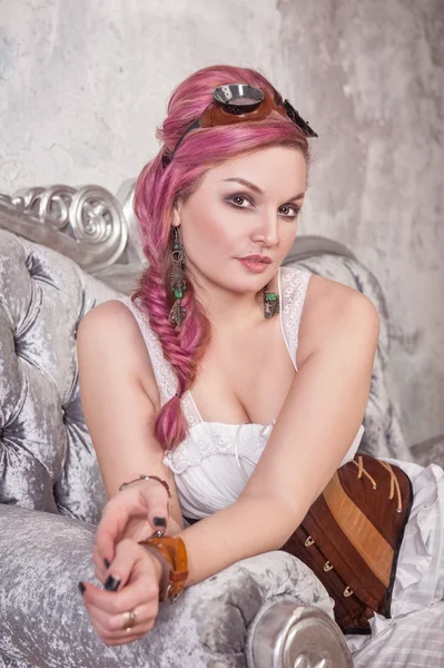 Beautiful steampunk woman on the sofa — Stock Photo, Image