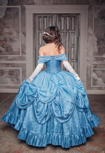 Beautiful medieval woman in blue dress, back 