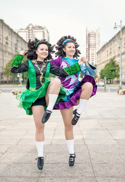 Two women in irish dance dresses dancing