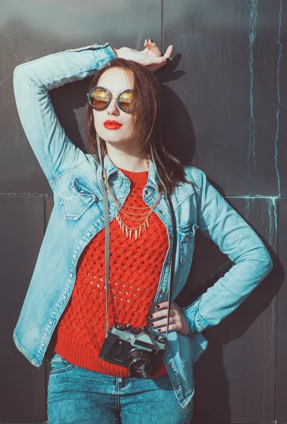 Young beautiful girl in red jersey with sunglasses — Stock Photo, Image