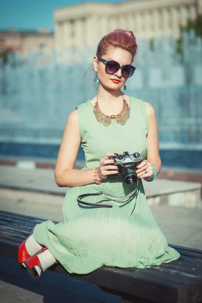 Beautiful girl in vintage clothing with retro camera — Stock Photo, Image